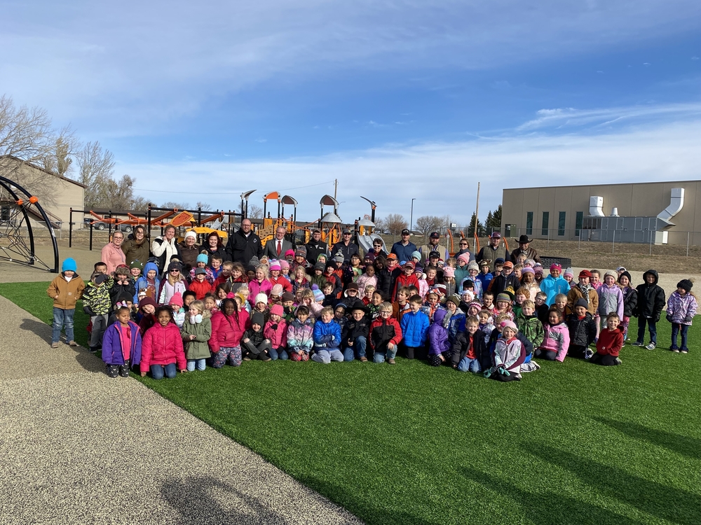 group of students and adults on playground 